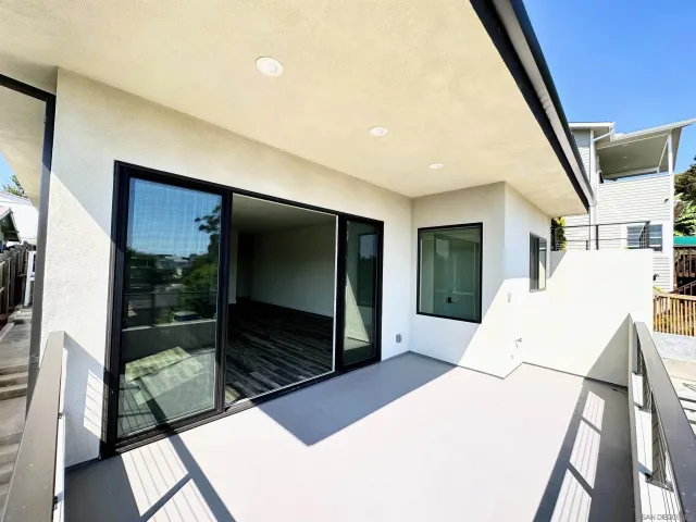a living room with a large window and a flat screen tv