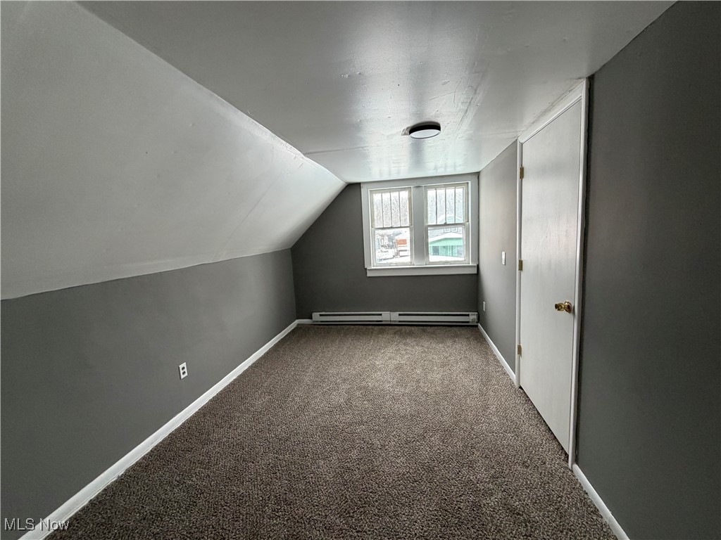 16309 Nela View Road Cleveland, OH 44112 - Photo 18 of 29 Bonus room featuring carpet flooring, vaulted ceiling, and baseboard heating