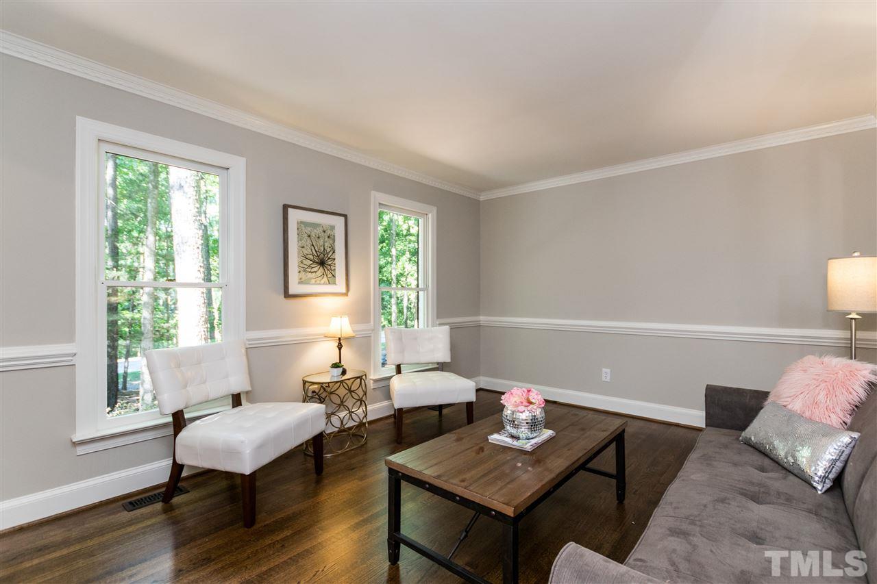 4908 Fielding Drive Raleigh, NC 27606 - Photo 11 of 25 This living room is such a nice size and would be a wonderful place to watch a little TV, curl up with a book, or put a piano in and make this a music room. Notice the beautiful hardwoods and the two windows look out onto the gorgeous wooded front yard.