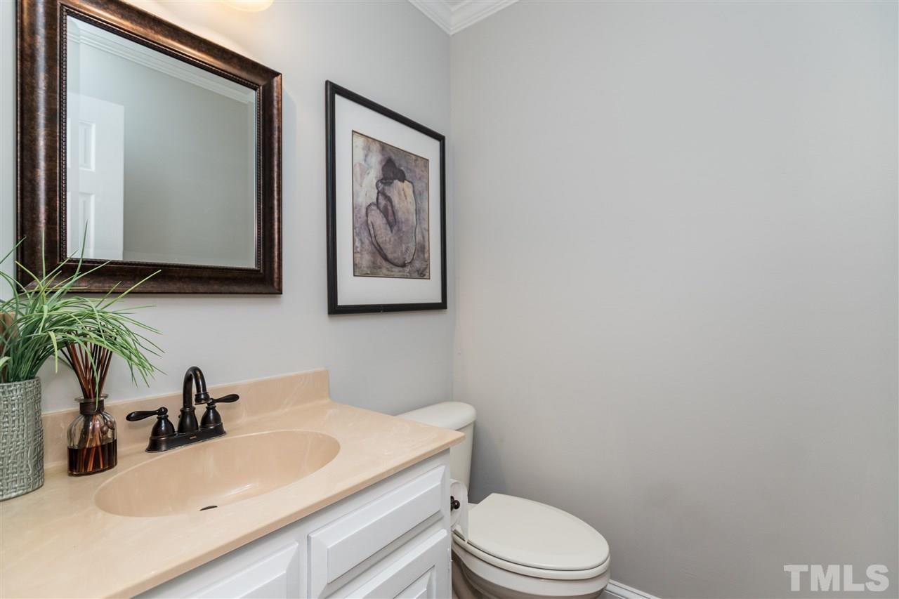 4908 Fielding Drive Raleigh, NC 27606 - Photo 12 of 25 The powder room is tastefully done with white vanity. The entire home inside and out has been painted. The entire downstairs is painted a soft dove great with bright white trim.