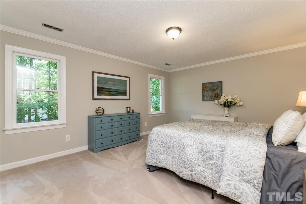 4908 Fielding Drive Raleigh, NC 27606 - Photo 14 of 25 The master bedroom has two large windows that look out into the trees of the backyard. There is plenty of room for several pieces of bedroom furniture and a king size bed.