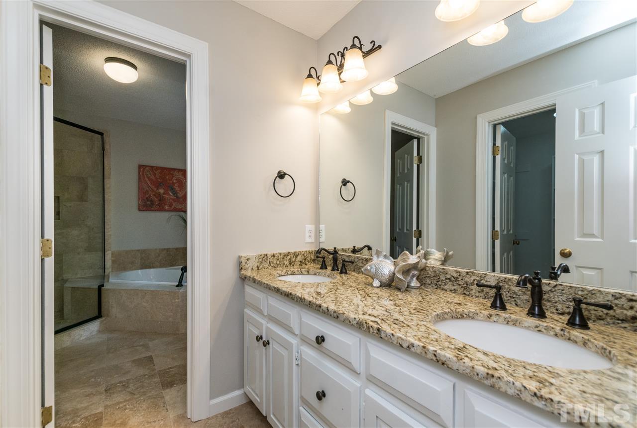 4908 Fielding Drive Raleigh, NC 27606 - Photo 15 of 25 Gorgeous, Gorgeous, Gorgeous! Master bath has dual sinks, a large vanity with tons of storage and counter space, modern lighting and fixtures. Did I mention that the counters are the most beautiful granite ever? Across from the vanity is the door to WIC.