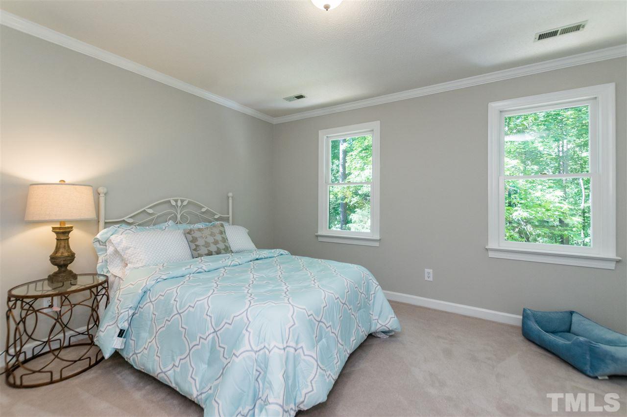 4908 Fielding Drive Raleigh, NC 27606 - Photo 17 of 25 There are four large bedrooms in this gorgeous home and a huge bonus room too! This is the first of the secondary bedrooms. It has brand new carpet, brand new lighting, and windows letting in soft natural light.