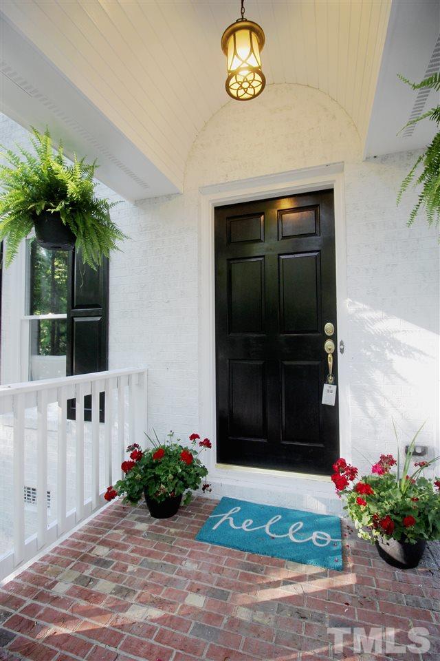 4908 Fielding Drive Raleigh, NC 27606 - Photo 3 of 25 This beautiful home has a driveway that winds gracefully up through the trees. A concrete pathway lined with crisp green hedges and red & pink flowers directs you to this sweet front porch. The barrel ceiling portico adds dramatic architectural interest!