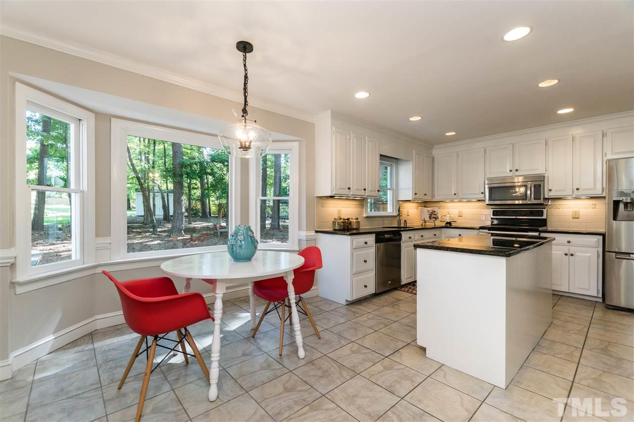 4908 Fielding Drive Raleigh, NC 27606 - Photo 6 of 25 Enjoy your morning coffee in this lovely breakfast nook. It features a stunning view of the backyard through the bay window. Notice the modern pendant light over the table! All light fixtures in the home has been updated! Most have LED lights too.