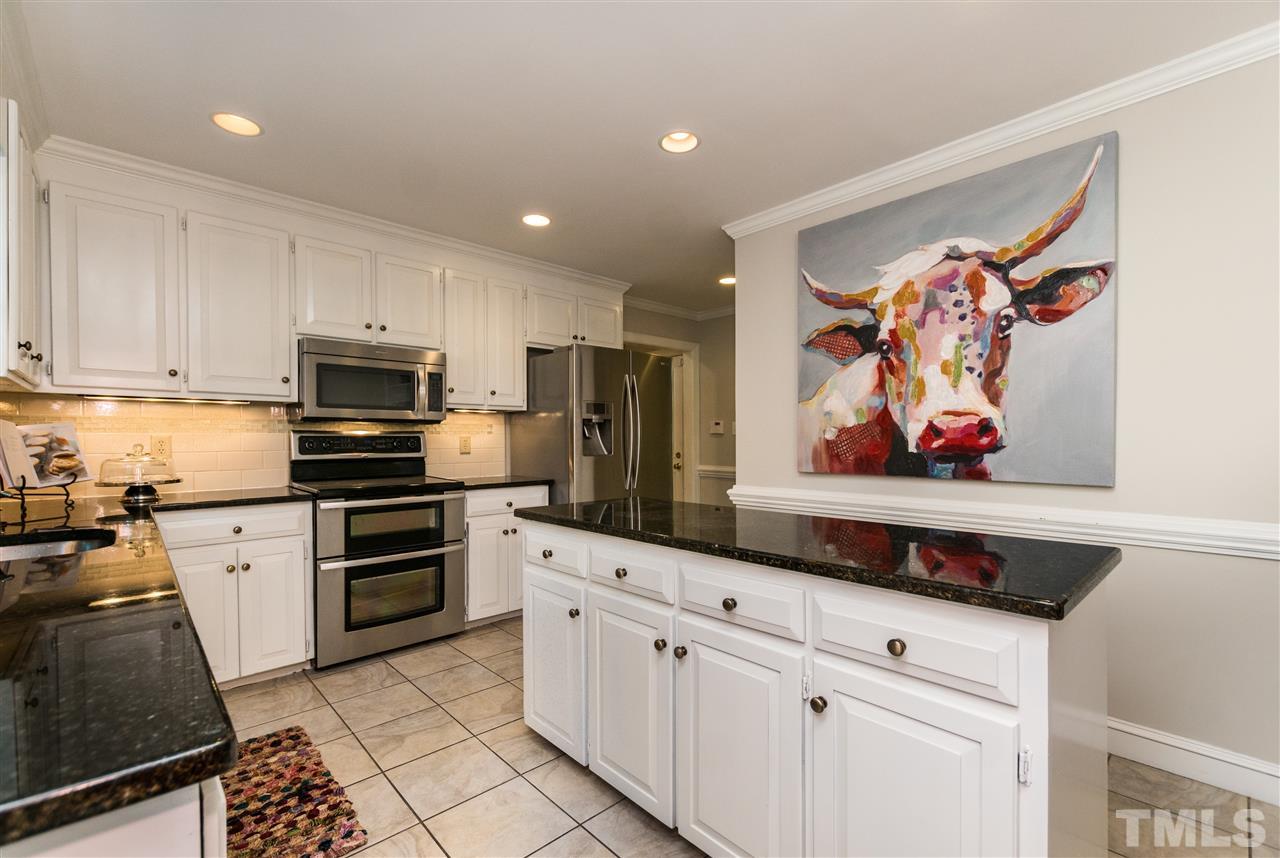 4908 Fielding Drive Raleigh, NC 27606 - Photo 9 of 25 There are stainless steel appliances, a stainless steel undermount sink, and lots of bright recessed lights! There are under cabinet lighting too and a neutral tiled backsplash.