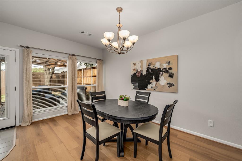 6053 Buffridge Trail Dallas, TX 75252 - Photo 11 of 40 a view of a dining room with furniture wooden floor and a chandelier