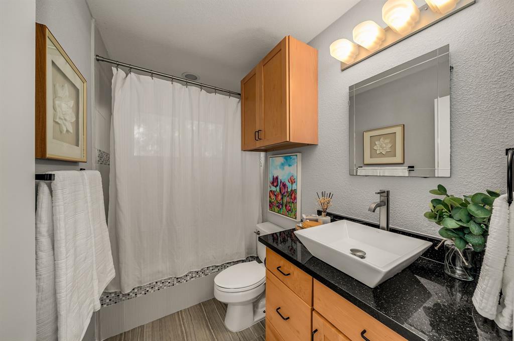 6053 Buffridge Trail Dallas, TX 75252 - Photo 19 of 40 a room with a sink toilet and mirror