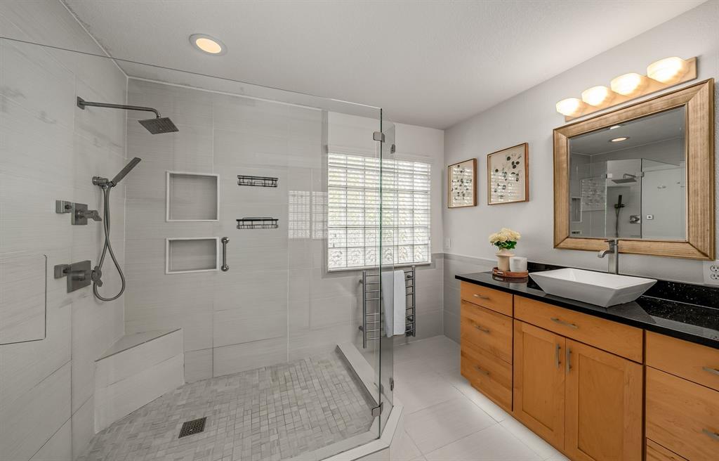 6053 Buffridge Trail Dallas, TX 75252 - Photo 24 of 40 a bathroom with a granite countertop sink a toilet and shower