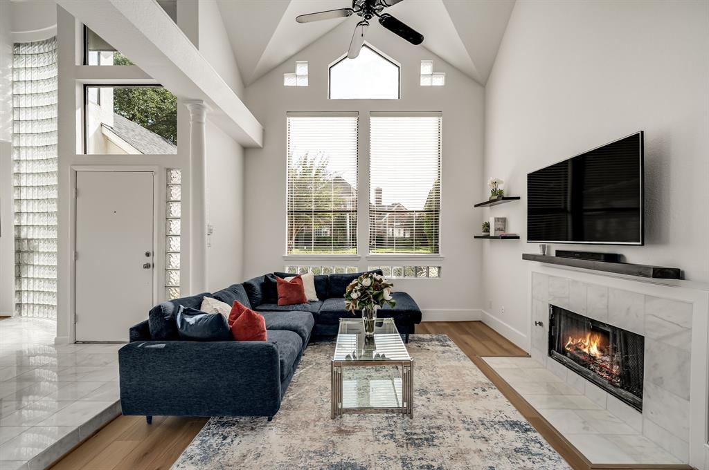 6053 Buffridge Trail Dallas, TX 75252 - Photo 6 of 40 a living room with furniture a flat screen tv and a fireplace