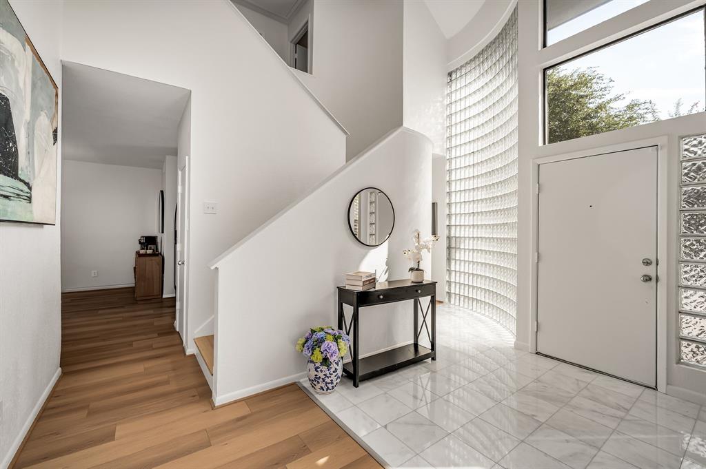 6053 Buffridge Trail Dallas, TX 75252 - Photo 9 of 40 a view of a hallway with wooden floor and entryway