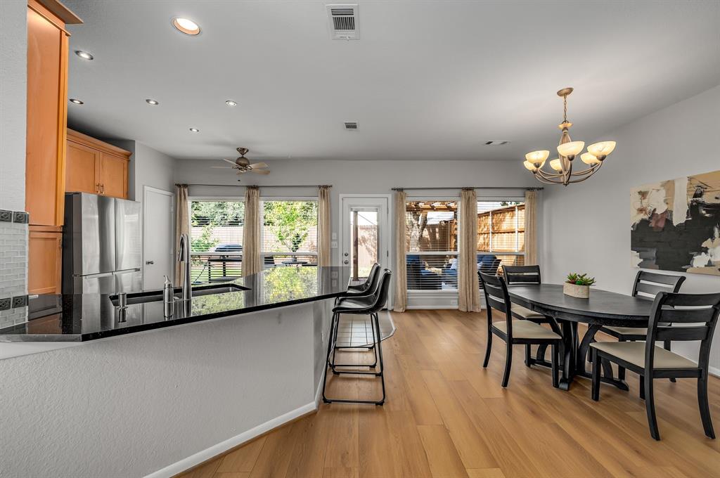 6053 Buffridge Trail Dallas, TX 75252 - Photo 10 of 40 a view of a dining room with furniture window and wooden floor
