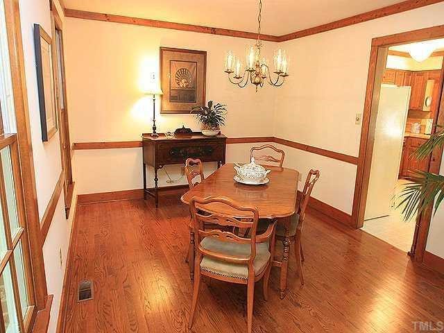 10220 Bushveld Lane Raleigh, NC 27613 - Photo 4 of 12 a view of a dining room with furniture and wooden floor