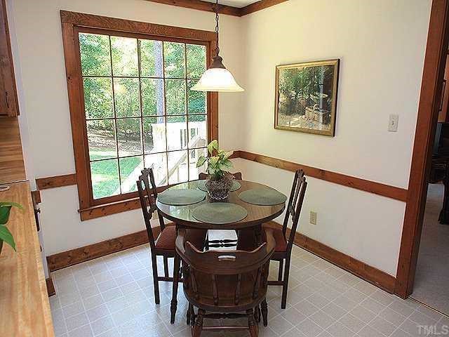 10220 Bushveld Lane Raleigh, NC 27613 - Photo 6 of 12 a view of a dining room with furniture window and wooden floor