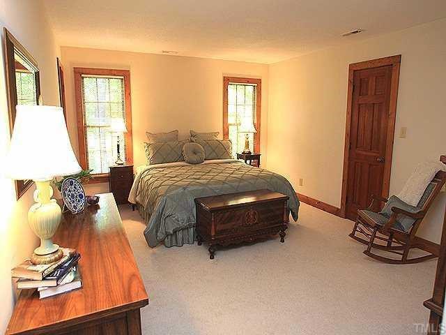 10220 Bushveld Lane Raleigh, NC 27613 - Photo 8 of 12 a bedroom with a bed and a window