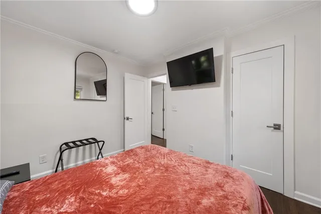 a view of a lake with a bench and trees in the background