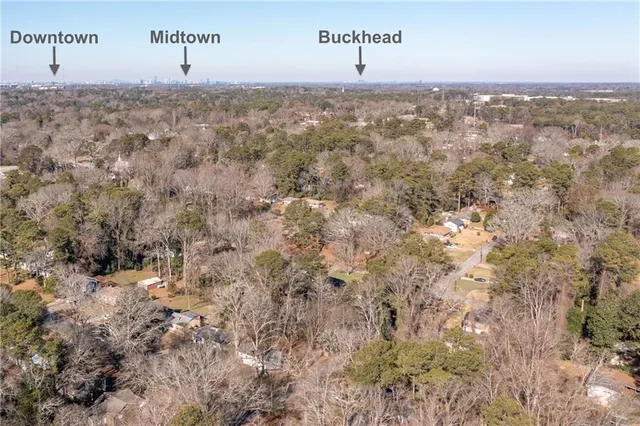 a view of a chair and table in backyard of the house