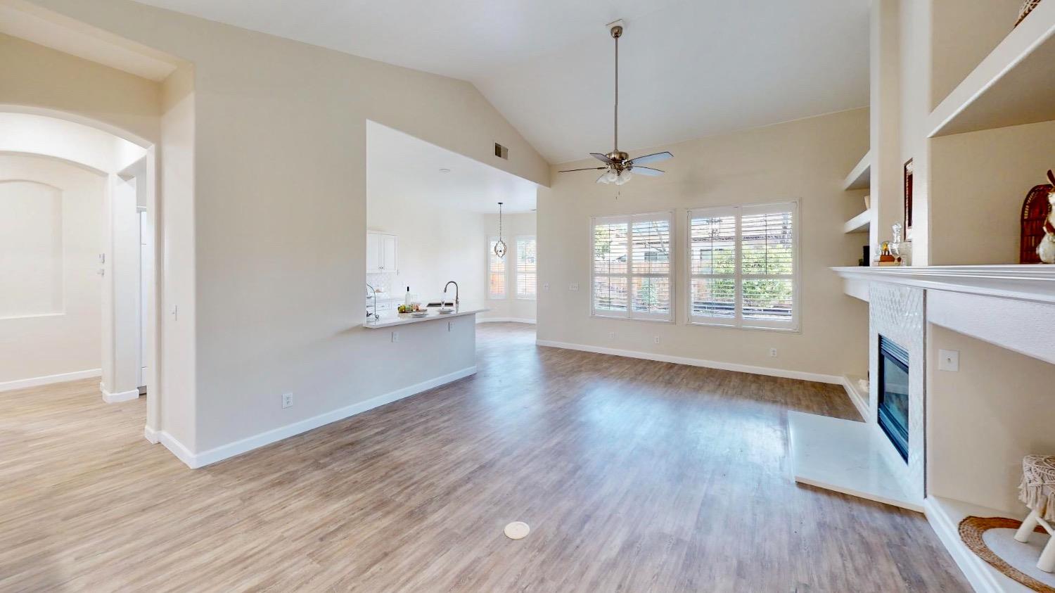 3051 Carson Avenue Clovis, CA 93611 - Photo 6 of 40 a view of an empty room with window and wooden floor