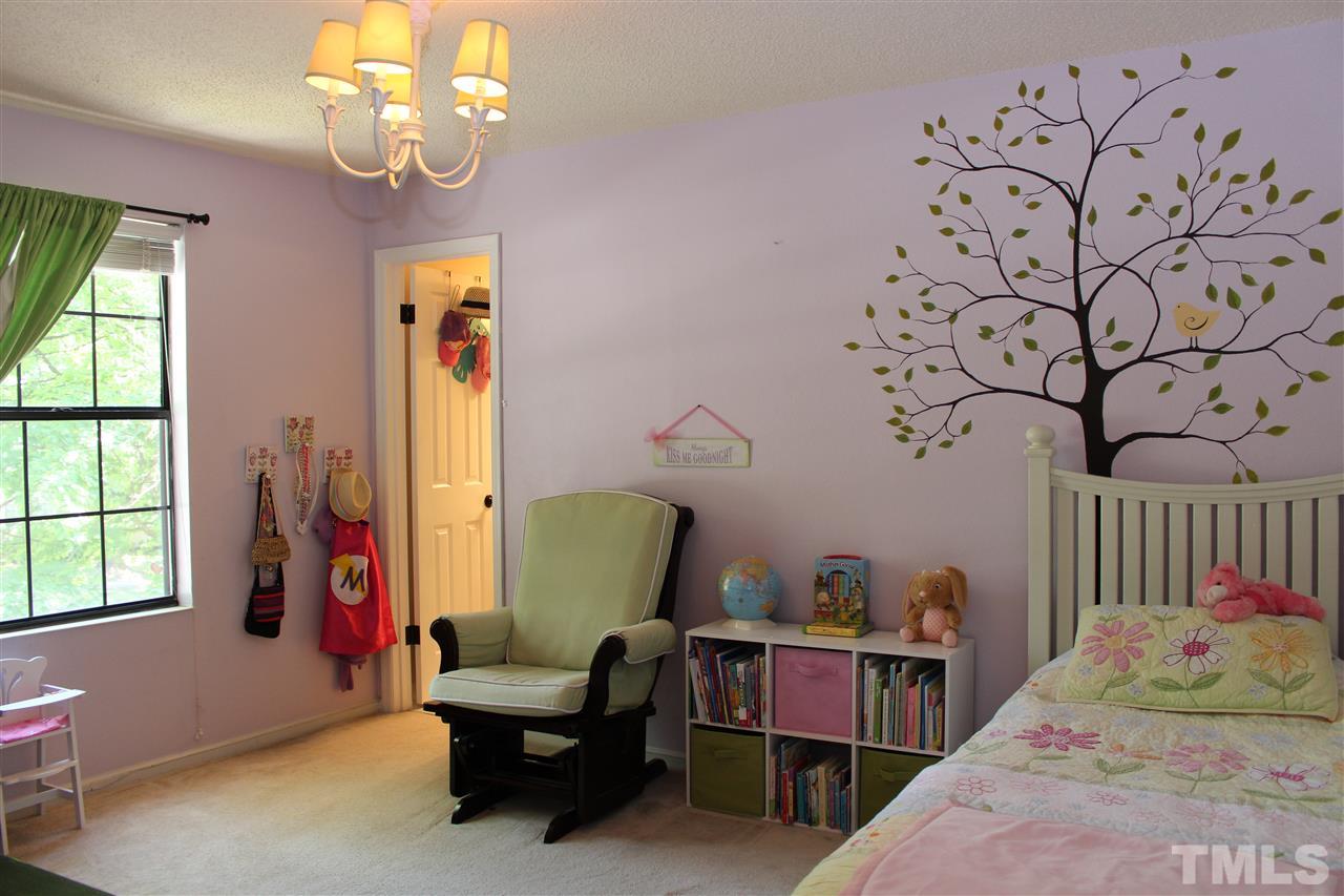 2423 Condor Court Raleigh, NC 27615 - Photo 11 of 20 a bedroom with a bed and a chandelier