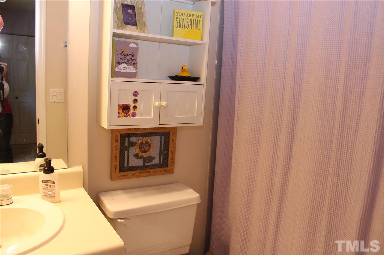 2423 Condor Court Raleigh, NC 27615 - Photo 12 of 20 a bathroom with a sink and a mirror