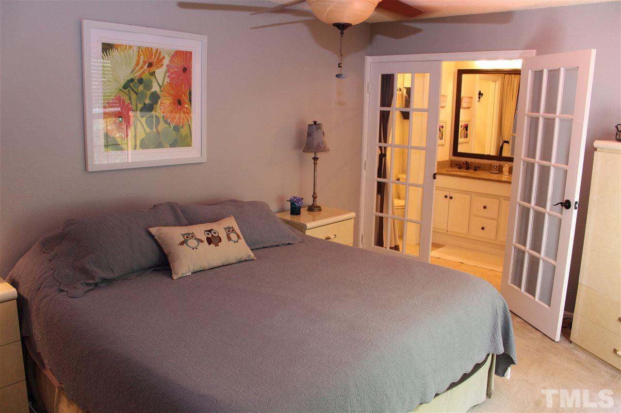 2423 Condor Court Raleigh, NC 27615 - Photo 13 of 20 a bedroom with a bed and a painting on the wall