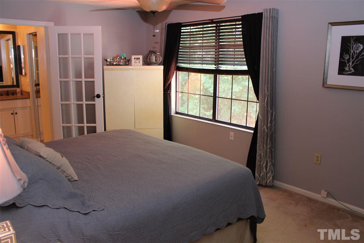 2423 Condor Court Raleigh, NC 27615 - Photo 14 of 20 a bed sitting in a bedroom next to a window