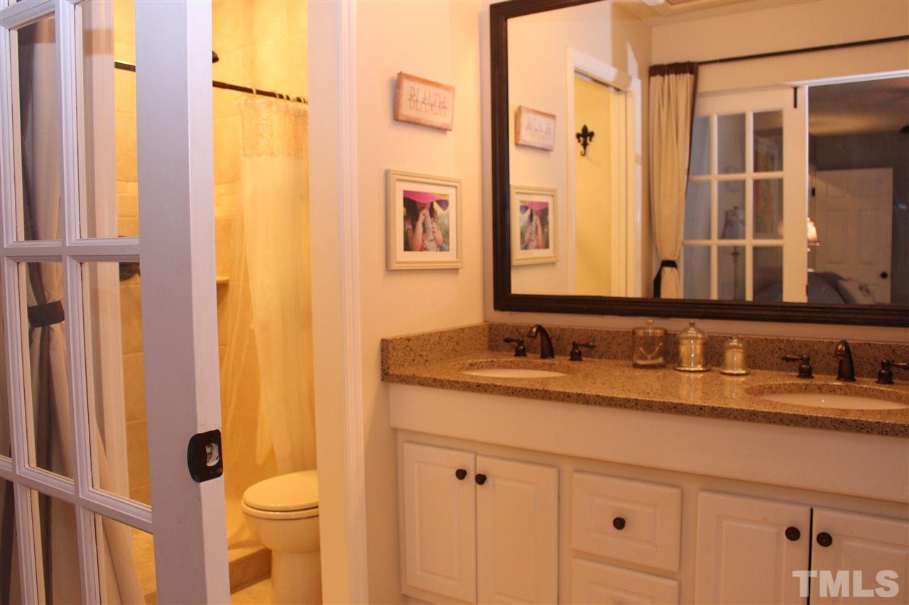2423 Condor Court Raleigh, NC 27615 - Photo 16 of 20 a bathroom with a granite countertop sink toilet and shower