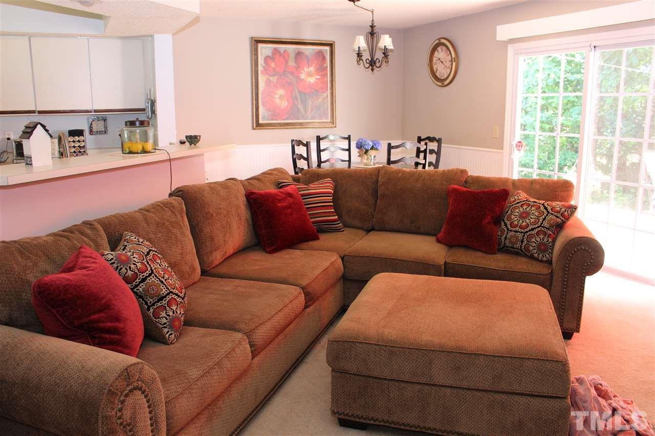 2423 Condor Court Raleigh, NC 27615 - Photo 3 of 20 a blue couch sitting in a kitchen living room with a couch