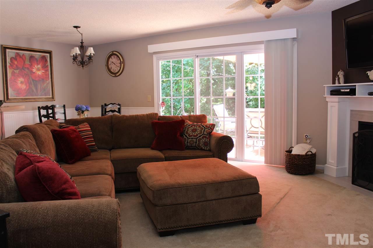 2423 Condor Court Raleigh, NC 27615 - Photo 4 of 20 a living room with furniture a flat screen tv and a window