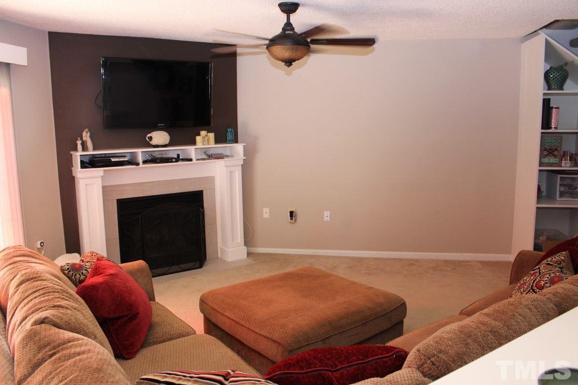 2423 Condor Court Raleigh, NC 27615 - Photo 5 of 20 a living room with furniture and a fireplace