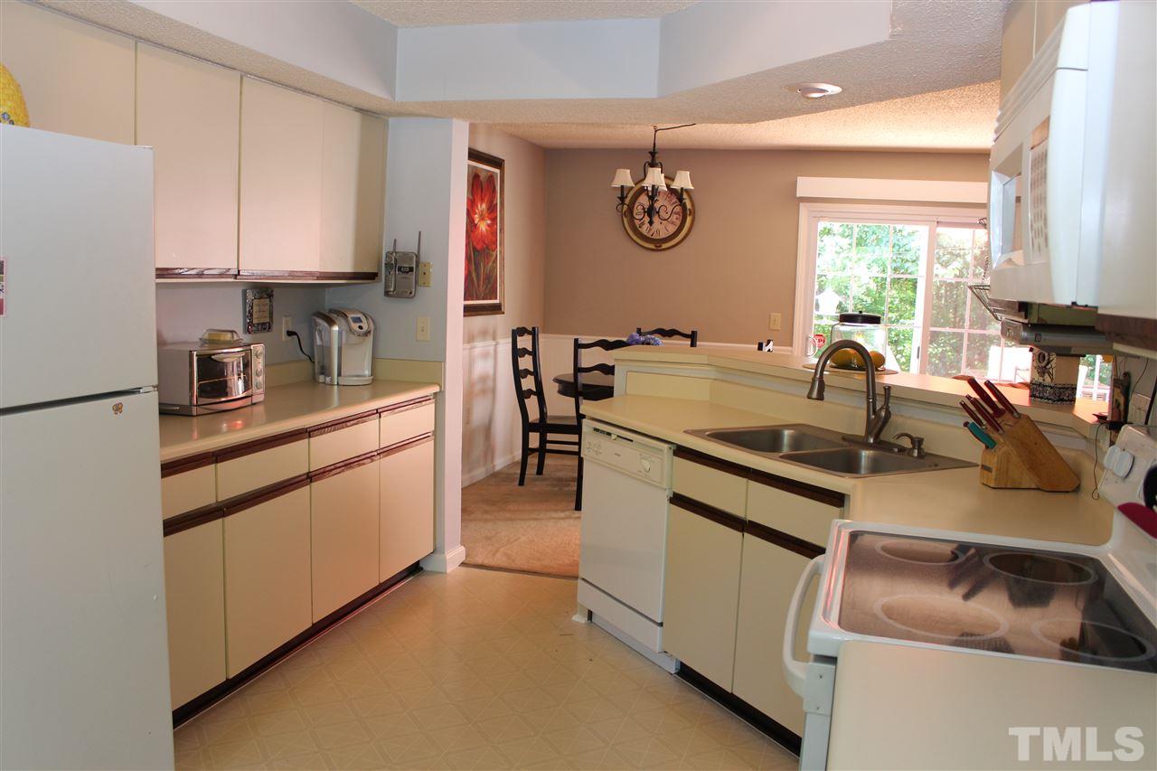 2423 Condor Court Raleigh, NC 27615 - Photo 7 of 20 a kitchen with a stove and a refrigerator