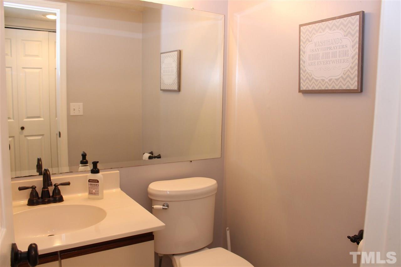 2423 Condor Court Raleigh, NC 27615 - Photo 10 of 20 a bathroom with a sink mirror and toilet