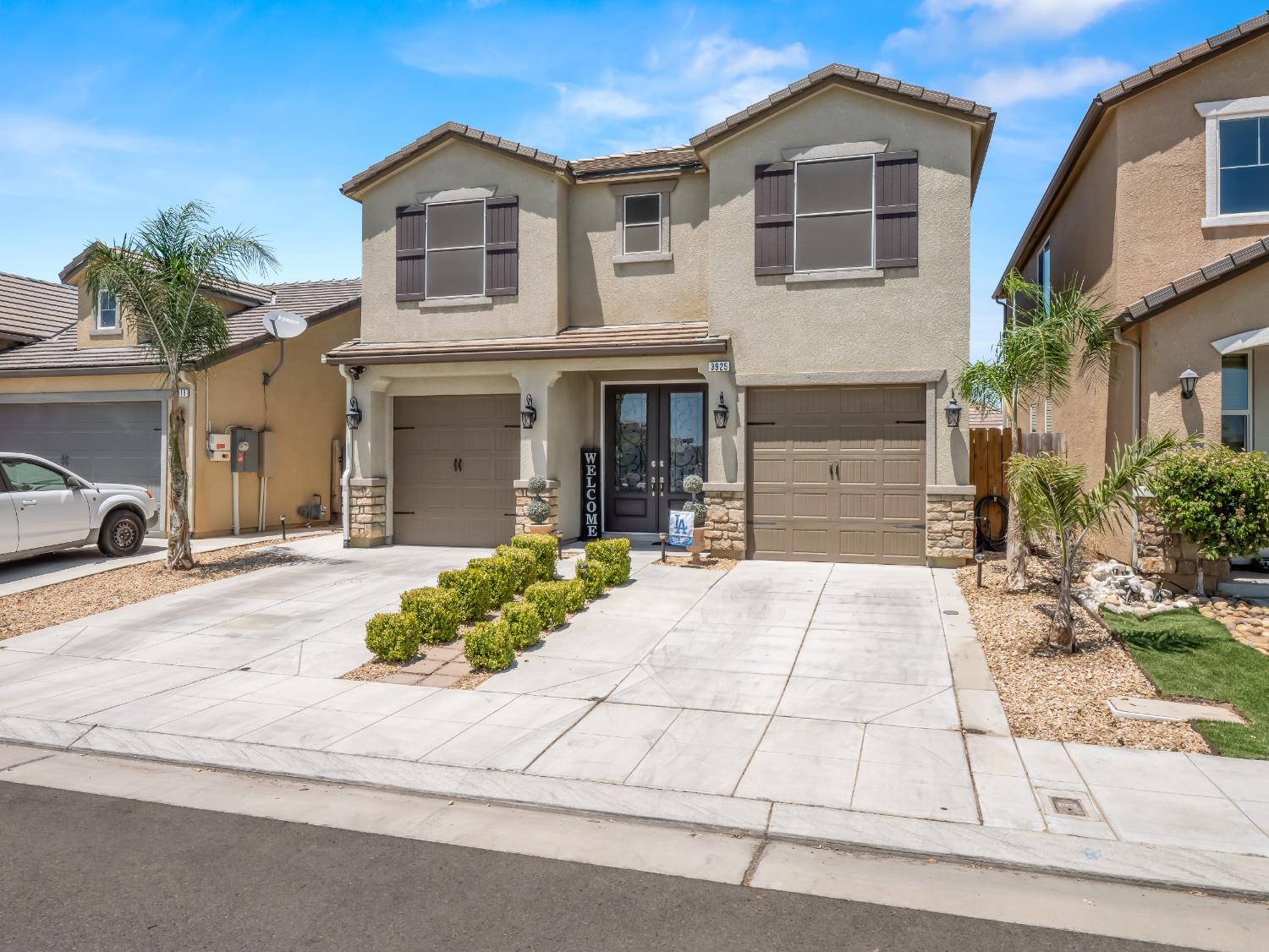 a front view of a house with a yard and a garage