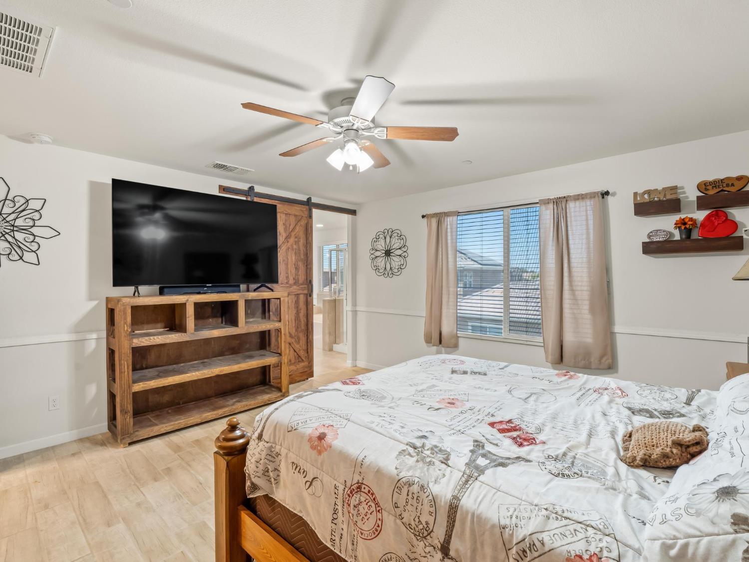 3925 Griffith Avenue Clovis, CA 93619 - Photo 14 of 40 a bedroom with a bed and a flat screen tv