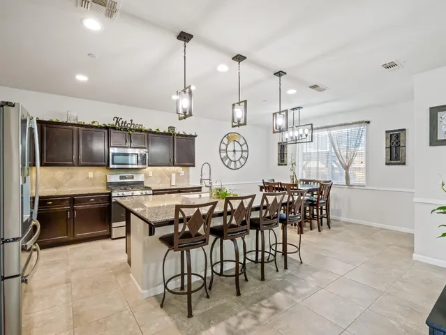 a large kitchen with a table and chairs in it
