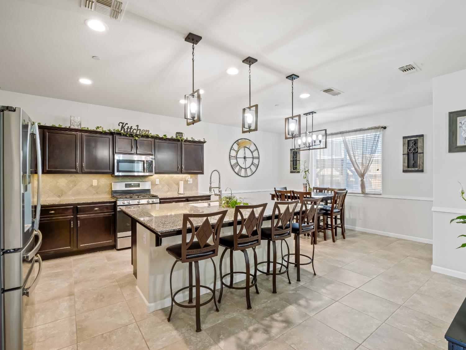 3925 Griffith Avenue Clovis, CA 93619 - Photo 23 of 40 a large kitchen with a table and chairs in it