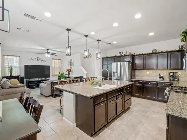 a large kitchen with a large counter top appliances and cabinets