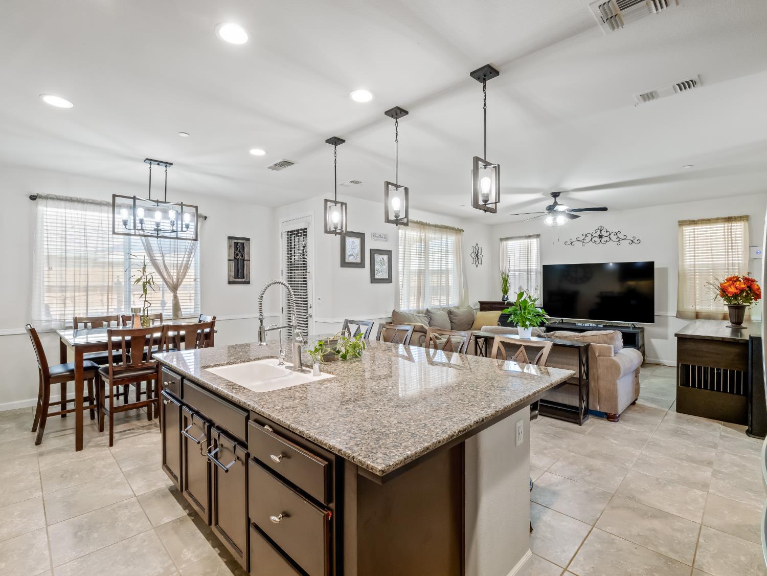 3925 Griffith Avenue Clovis, CA 93619 - Photo 32 of 40 a large kitchen with a table and chairs