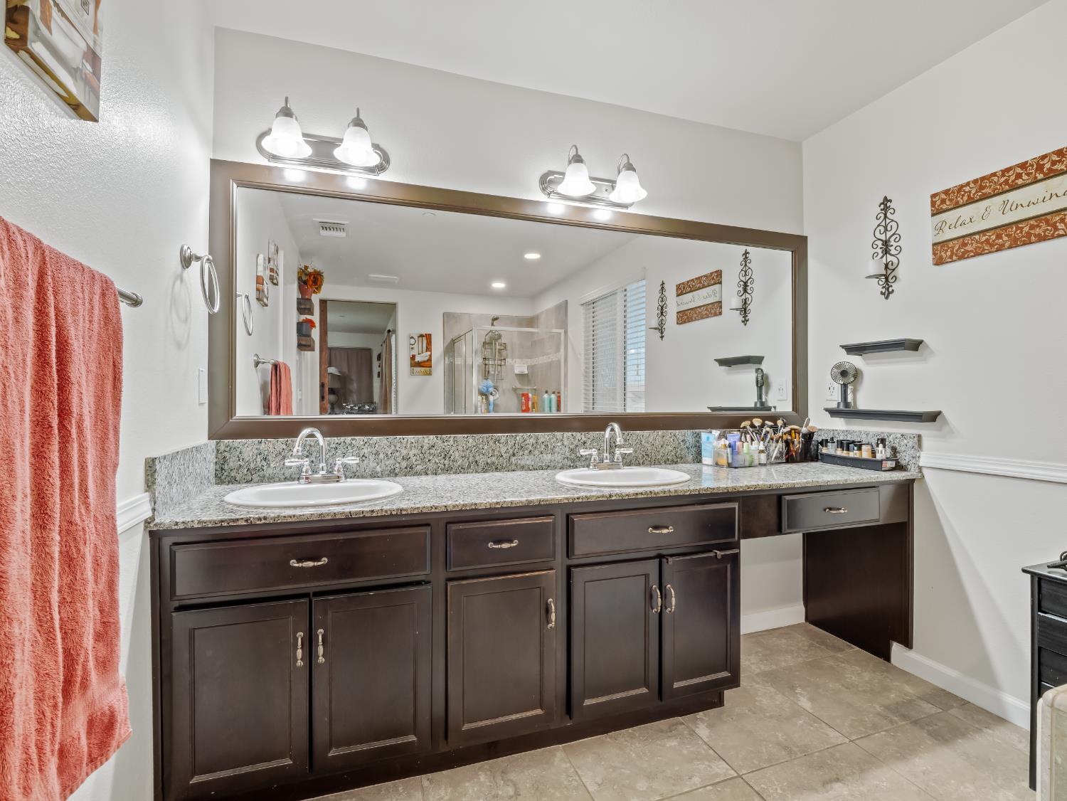 3925 Griffith Avenue Clovis, CA 93619 - Photo 5 of 40 a bathroom with a granite countertop sink a large mirror and a