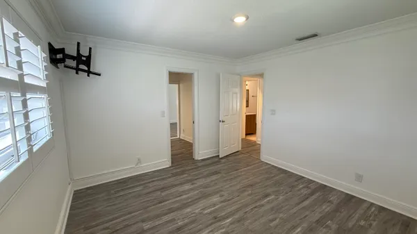 a view of empty room with wooden floor