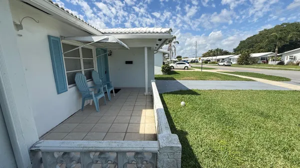 a view of a patio with table and chairs