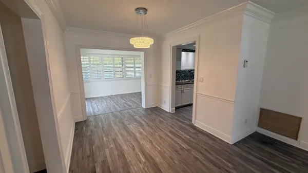 a kitchen with a sink a stove cabinets and wooden floor