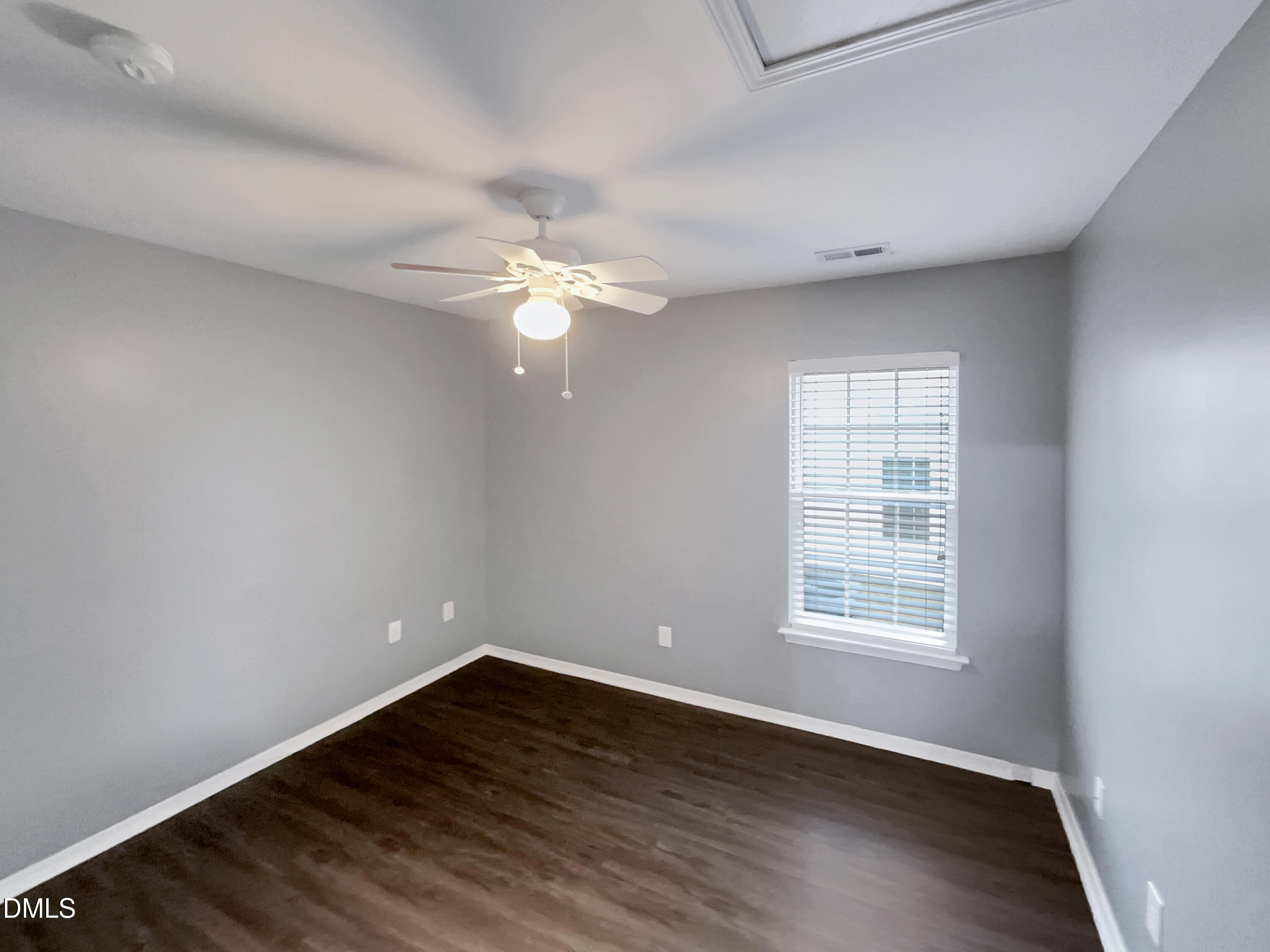 5400 Thunderidge Drive Raleigh, NC 27610 - Photo 12 of 15 an empty room with wooden floor and windows