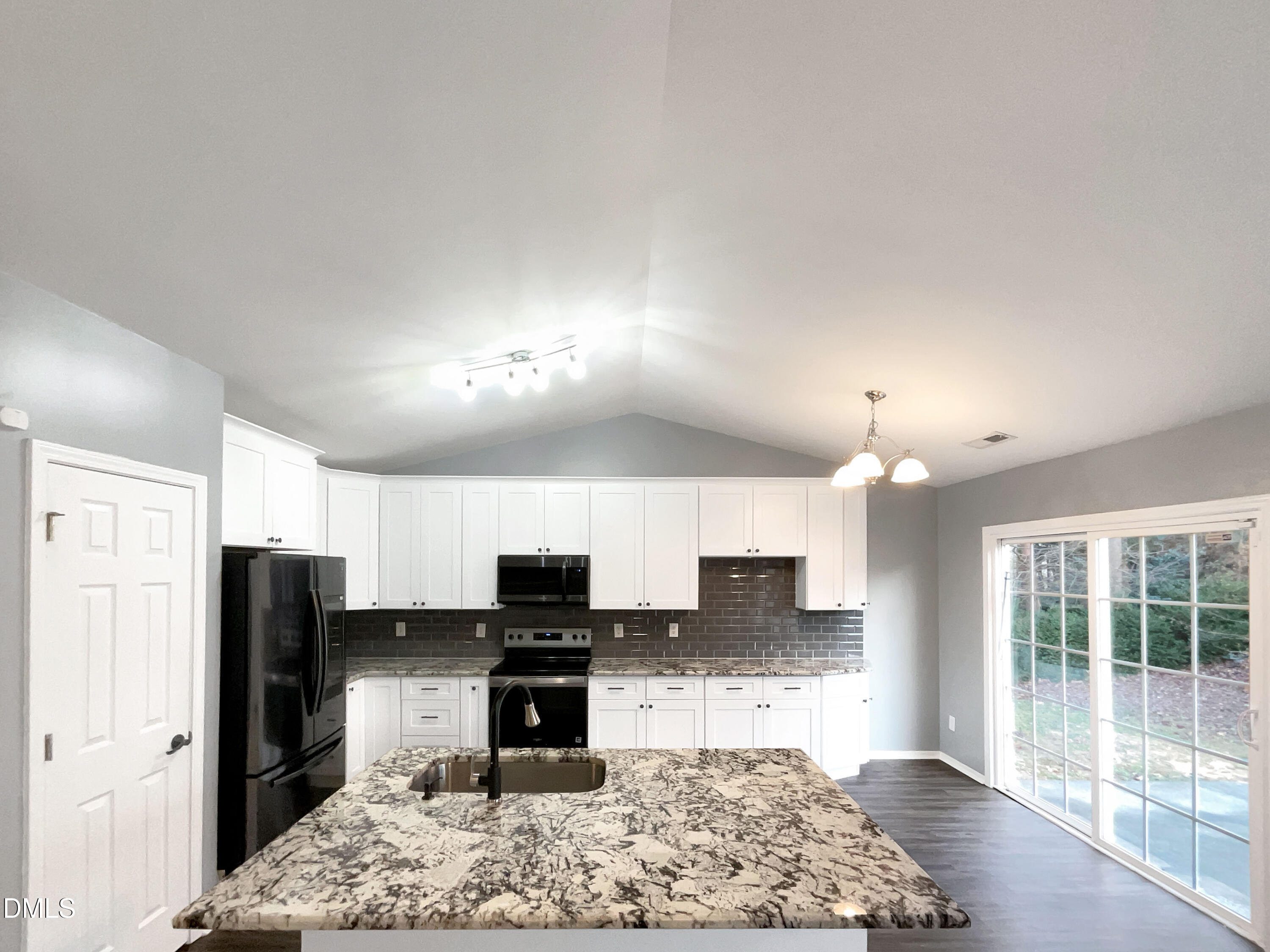 5400 Thunderidge Drive Raleigh, NC 27610 - Photo 2 of 15 a kitchen with stainless steel appliances kitchen island granite countertop a refrigerator stove top oven and sink