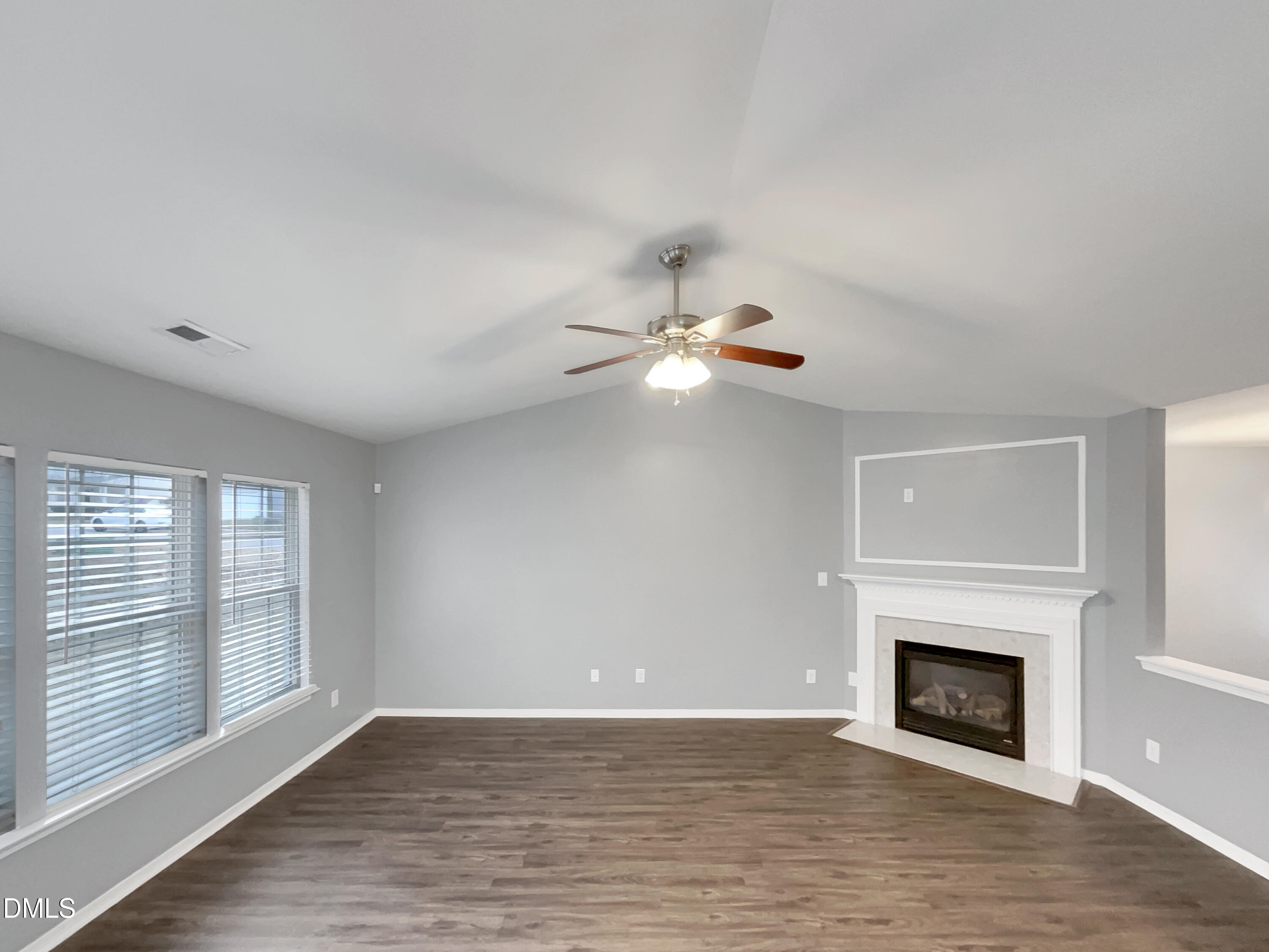 5400 Thunderidge Drive Raleigh, NC 27610 - Photo 3 of 15 a view of empty room with fireplace and wooden floor