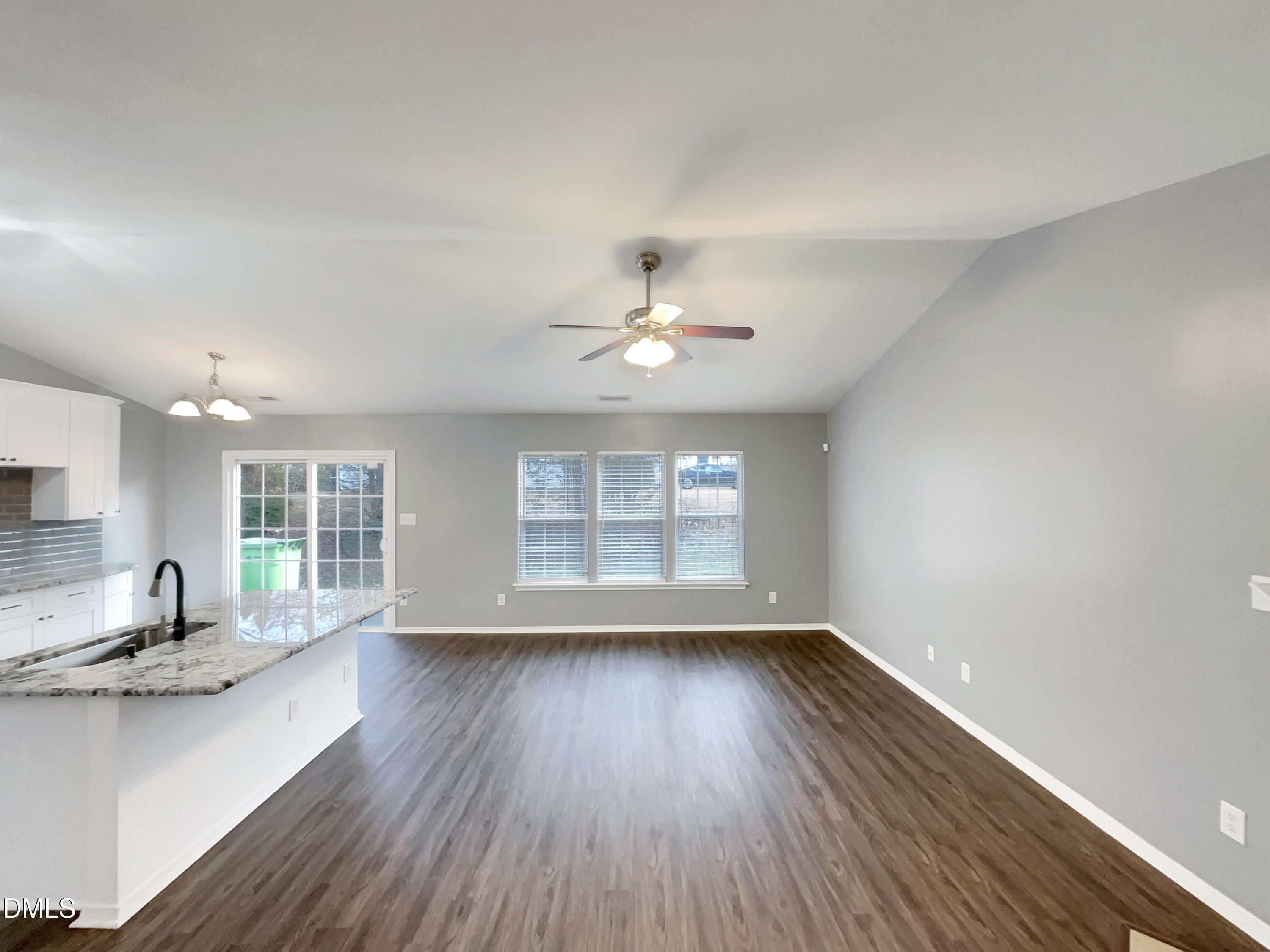 5400 Thunderidge Drive Raleigh, NC 27610 - Photo 6 of 15 a view of an empty room with a window and wooden floor