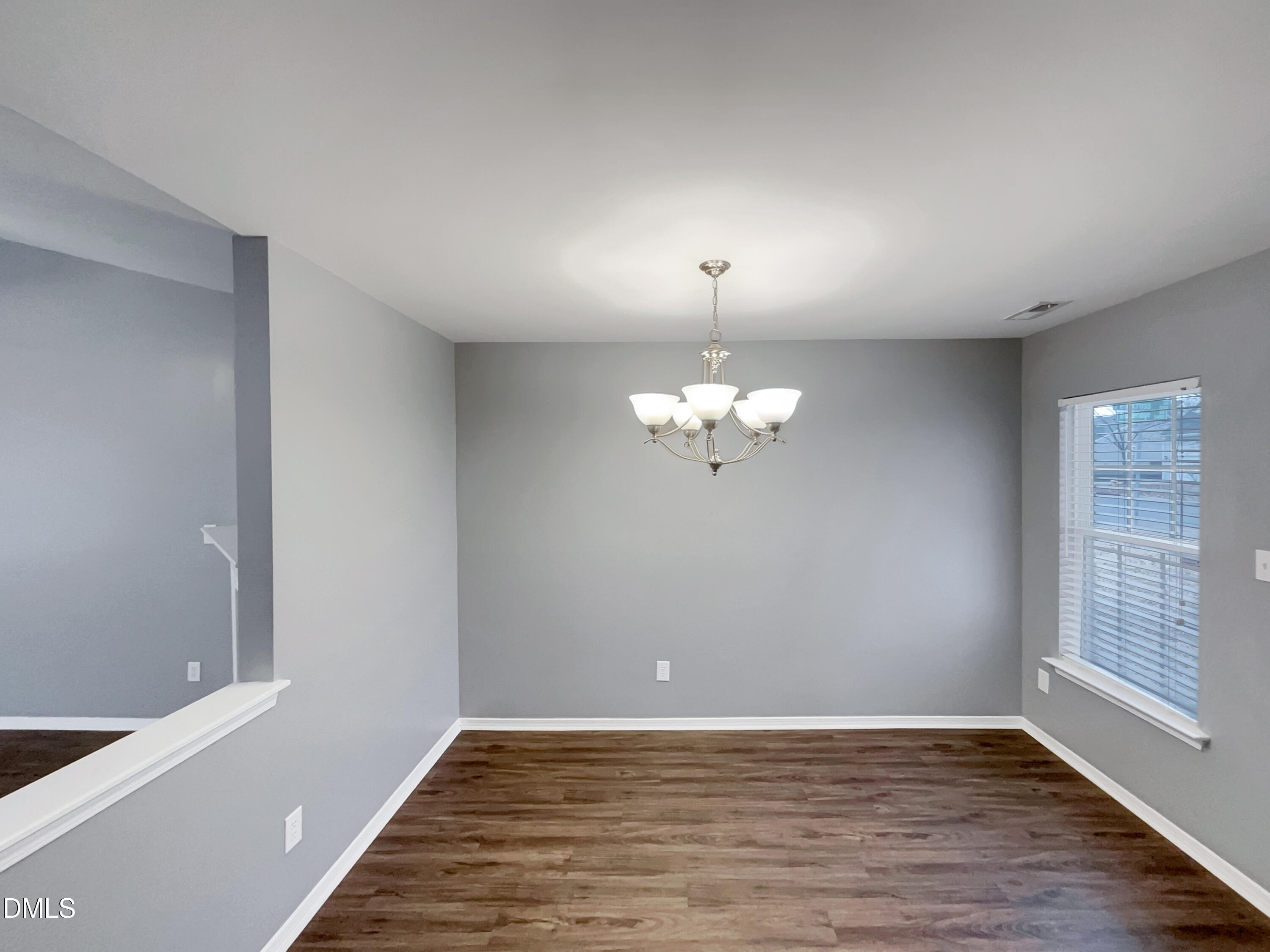 5400 Thunderidge Drive Raleigh, NC 27610 - Photo 7 of 15 a view of an empty room with wooden floor and a window
