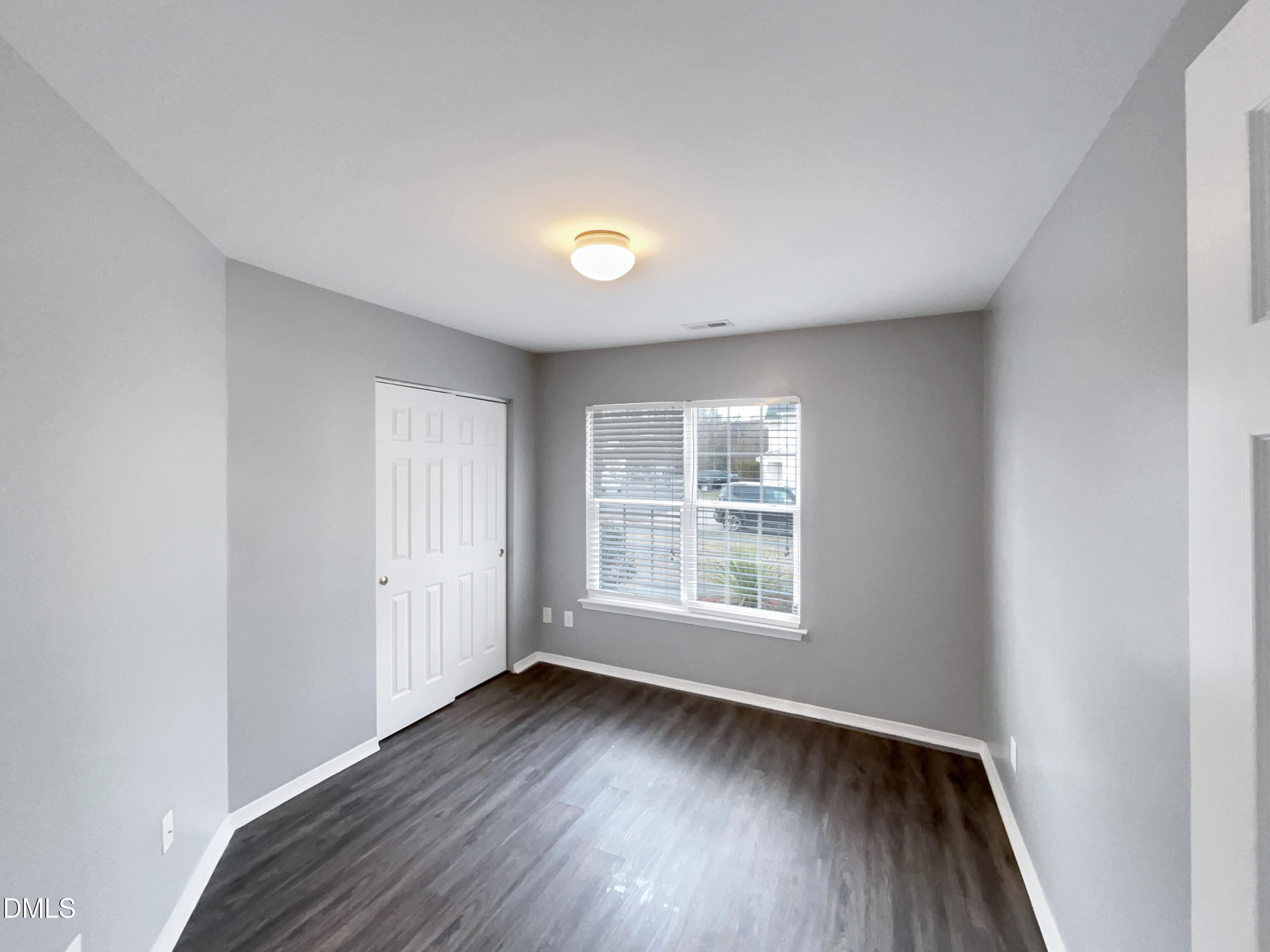 5400 Thunderidge Drive Raleigh, NC 27610 - Photo 10 of 15 an empty room with wooden floor and windows
