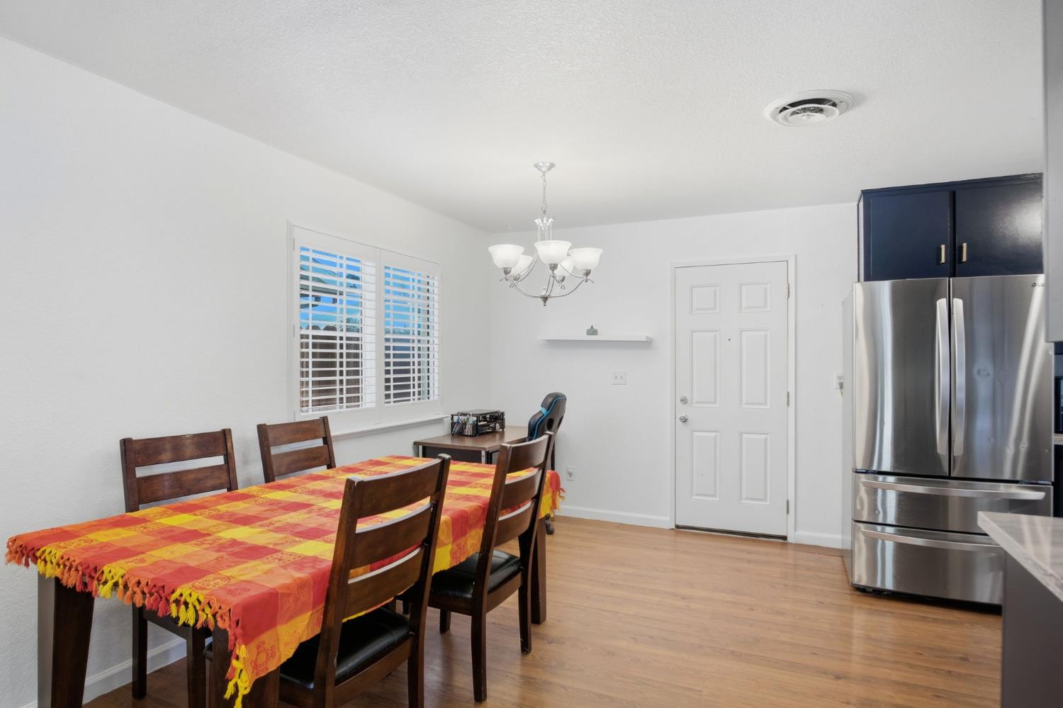 1308 Basil Court Newman, CA 95360 - Photo 8 of 20 a dining room with furniture and wooden floor