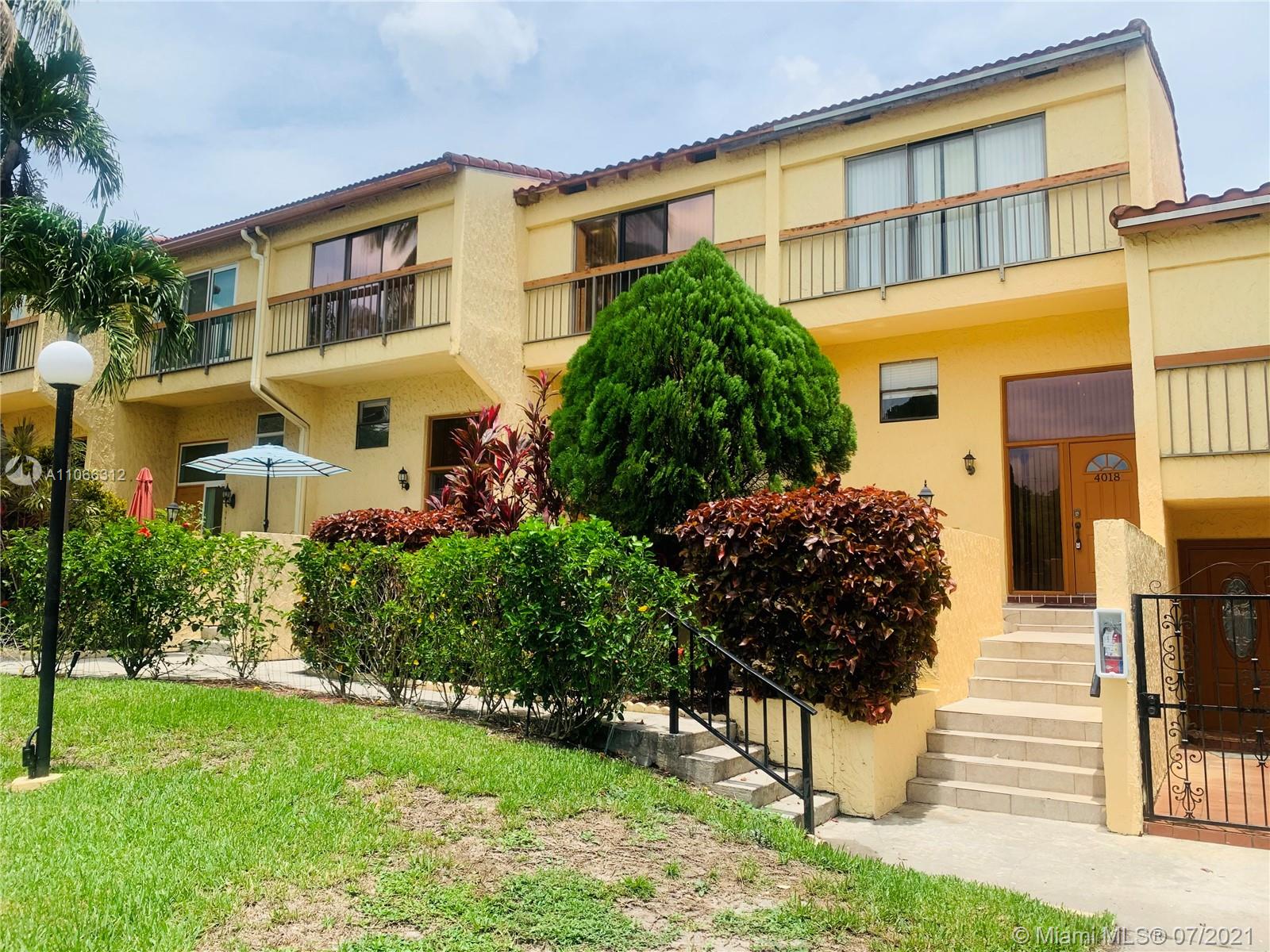 4018 Del Rio Way, Unit 4018 Sunrise, FL 33351 - Photo 1 of 94 a front view of a residential apartment building with a yard